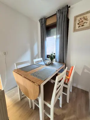 a dining room table and chairs in a room at Terme Banovci - Pomurski raj, tickets included in Veržej
