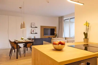 a kitchen and living room with a bowl of fruit on a table at Apartment Bovec by Liza in Bovec