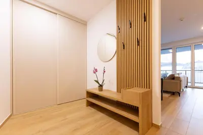a living room with a mirror and a table at Apartment Bovec by Liza in Bovec