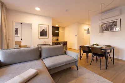 a living room with a couch and a dining room at Apartment Bovec by Liza in Bovec