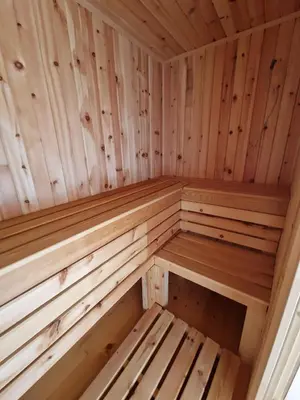 a wooden sauna with wooden benches in it at Izba in Lendava