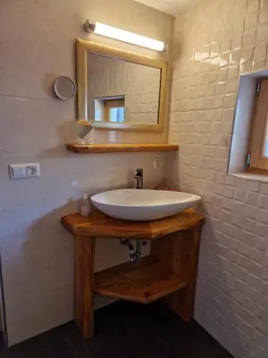 a bathroom with a white sink and a mirror at Izba in Lendava