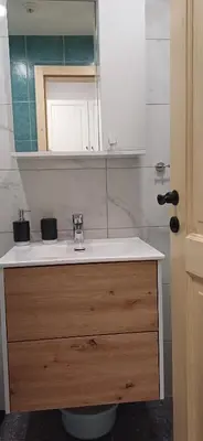 a bathroom with a sink and a mirror at HIŠA MARGIT, Studio APARTMA in Rateče
