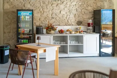 a coffee shop with a table and a counter at Landhouse Bled in Selo pri Bledu