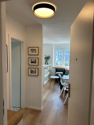 a living room with a table and a dining room at Lamant Apartment Cerkno in Cerkno