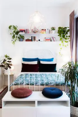 a room with a bed with pillows on it at Central Garden Studio in Ljubljana