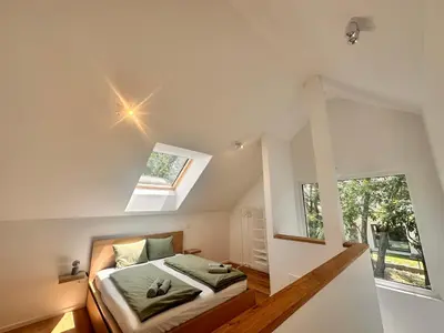 a bedroom with a bed and a window at Sitara's Chalet in Bled