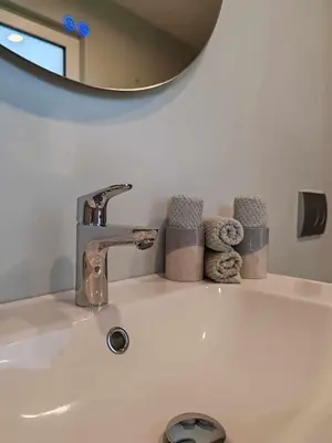 a bathroom sink with a faucet and a mirror at Sitara's Chalet in Bled