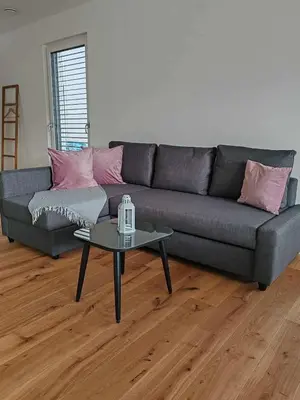 a living room with a couch and a table at Sitara's Chalet in Bled