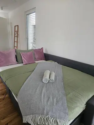a bed with two towels on top of it at Sitara's Chalet in Bled