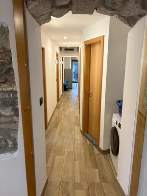 a hallway with a hallway leading to a room at Fedrig Hostel rooms Apartment for 10 in Kobarid