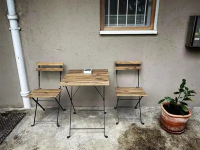 a table and two chairs next to a wall at Manca's Apartment with Free Parking in Ljubljana