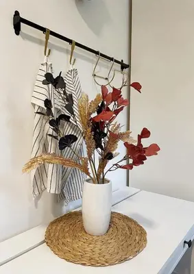 a white vase with flowers in it on a table at Manca's Apartment with Free Parking in Ljubljana