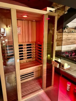 a room with a sauna with red lights in it at Celje Spa Apartment in Celje