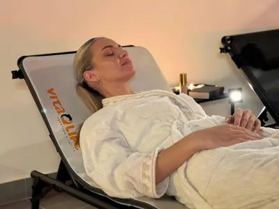 a woman laying in a hospital bed at Celje Spa Apartment in Celje