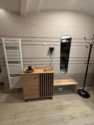 a dressing room with a large mirror on the wall at Celje Spa Apartment in Celje