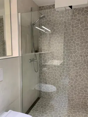a shower with a glass door in a bathroom at Apartment Center in Bled