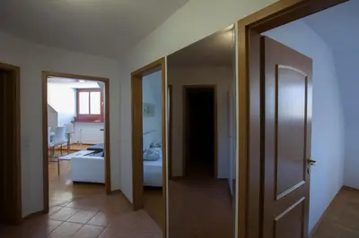 a hallway leading to a room with a mirror at Apartment Center in Bled