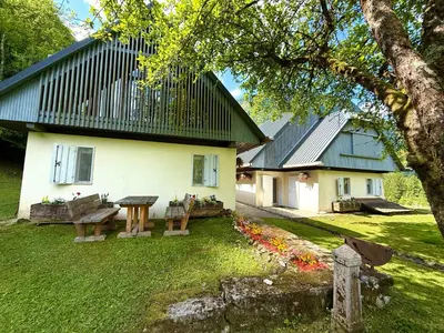 a house with a picnic table in front of it at Soča Village in Soča