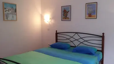 a bedroom with a bed with blue pillows on it at Apartments Ručna in Kobarid