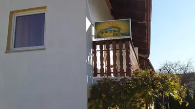 a sign on the side of a building with a balcony at Apartments Ručna in Kobarid