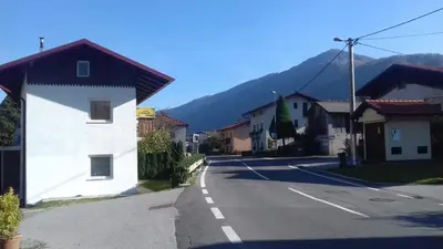 an empty street in a town with a mountain at Apartments Ručna in Kobarid