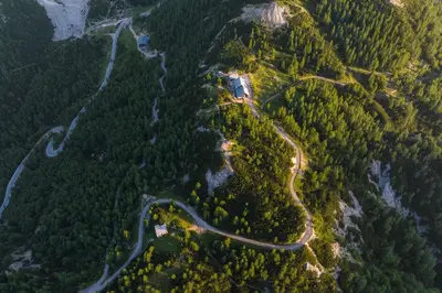 an aerial view of a road in a forest at Poštarski dom on Vršič in Kranjska Gora