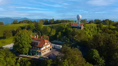 an aerial view of a building with a water tower at Tončkov dom na Lisci in Sevnica
