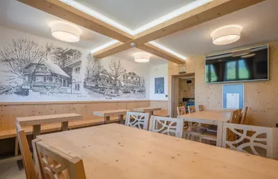 a dining room with wooden tables and chairs at Tončkov dom na Lisci in Sevnica