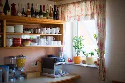 a kitchen with a coffee maker and a window at Rooms&Apartments Pazlar in Bled