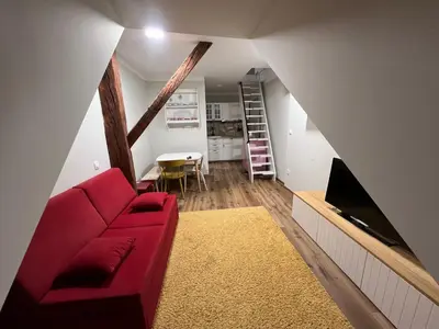 a living room with a red couch and a tv at Apartma G Vrhnika in Vrhnika