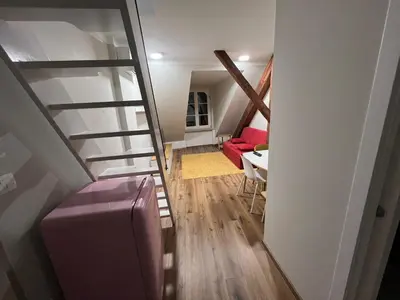a staircase leading to a living room with a red couch at Apartma G Vrhnika in Vrhnika