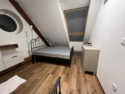 a small room with a bed and a window at Apartma G Vrhnika in Vrhnika
