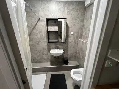 a small bathroom with a sink and a toilet at Apartma G Vrhnika in Vrhnika
