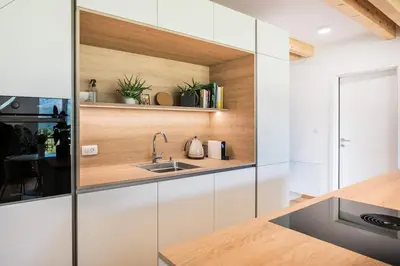 a kitchen with white cabinets and a sink at Nomad 27 in Bovec