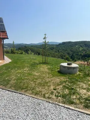 a field with a bird bath in the grass at Borl Apartment in Gradišča