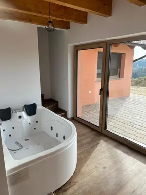 a white bath tub in a room with a window at Borl Apartment in Gradišča