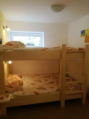 two bunk beds in a room with a window at Apartments Grudnik in Kranjska Gora