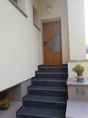 a set of stairs with a wooden door at Apartments Grudnik in Kranjska Gora