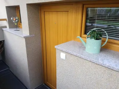 a potted plant sitting on a counter next to a window at Apartments Grudnik in Kranjska Gora