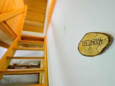 a sign that says happy hanging on a wall next to a ladder at Rustic House 13 in Bohinj