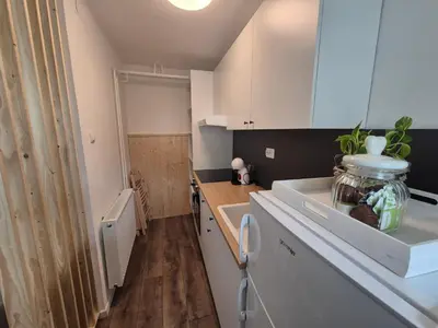 a kitchen with white cabinets and a counter top at Holiday Home Mila in Spodnja Idrija