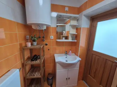 a bathroom with a sink and a mirror at Holiday Home Mila in Spodnja Idrija