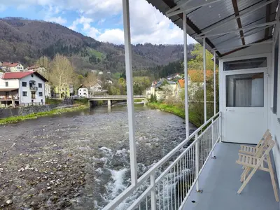 a balcony with a view of a river at Holiday Home Mila in Spodnja Idrija