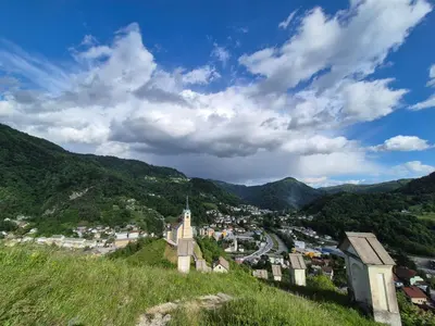a view of a town from a hill at Holiday Home Mila in Spodnja Idrija