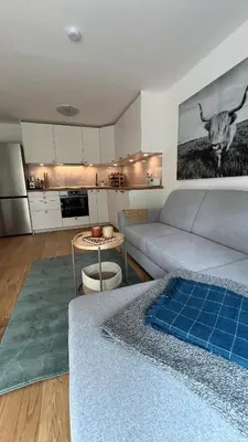 a living room with a couch and a table at Cosy getaway in raw nature in Šentjur