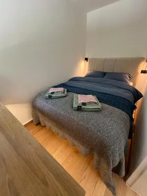a bedroom with a bed with two towels on it at Cosy getaway in raw nature in Šentjur