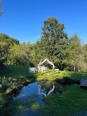 a picnic set up next to a pond in a park at Cosy getaway in raw nature in Šentjur