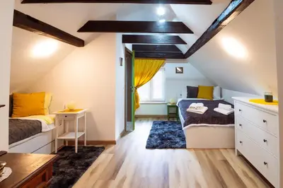 a attic bedroom with a bed and a desk at Apartment Grič with Sauna in Stari Trg pri Ložu