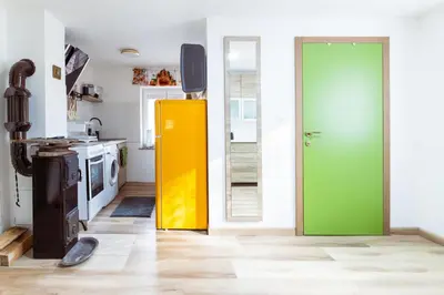 a kitchen with a green and yellow door in a room at Apartment Grič with Sauna in Stari Trg pri Ložu